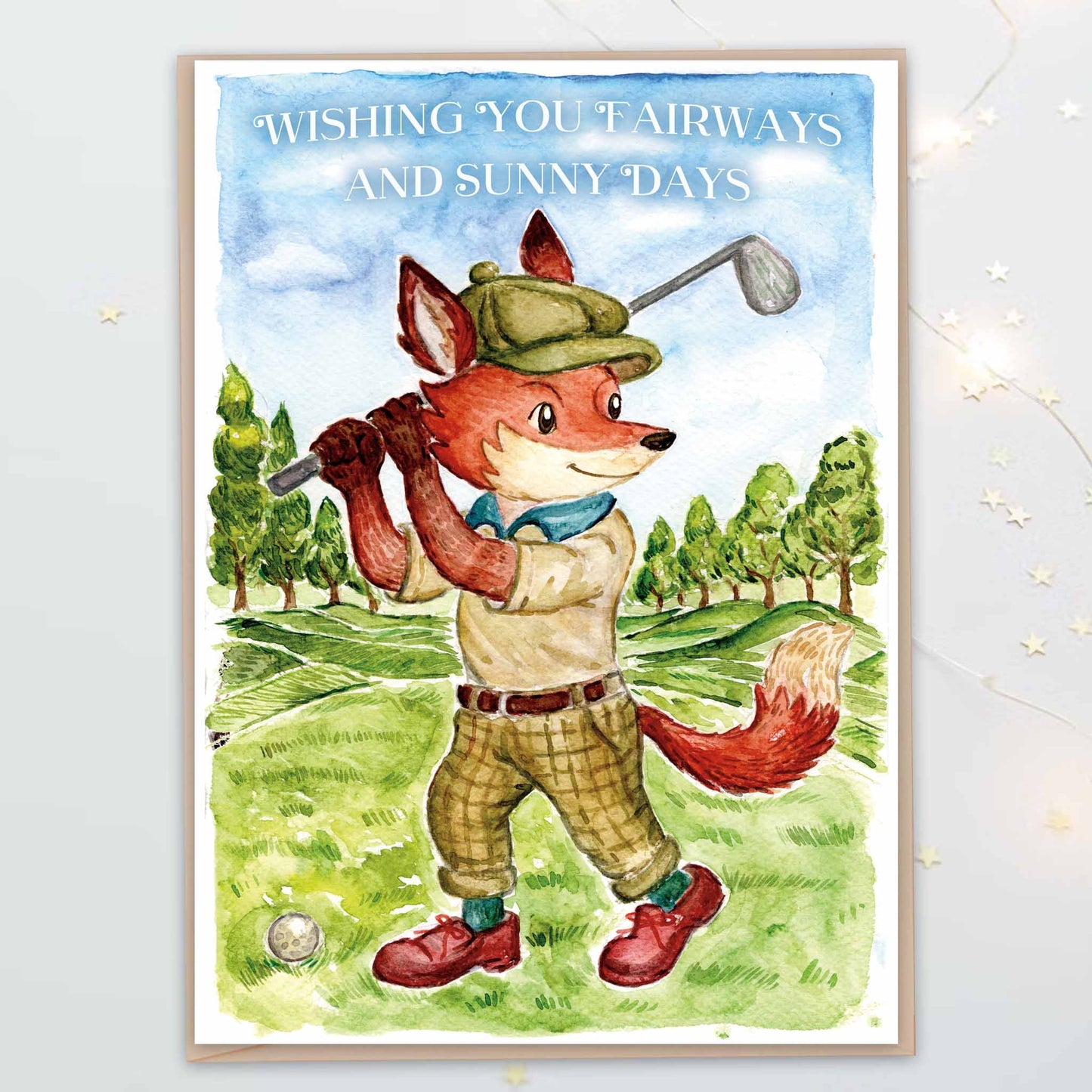 Watercolour illustrated greeting card of a fox playing golf on a scenic golf course with texts "Wishing you fairways and sunny days".