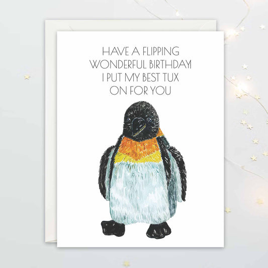 Card with a penguin illustration and humorous birthday message on a white background "Have a flipping wonderful birthday! I put my best tux on for you"