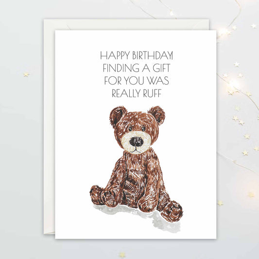 Birthday card with a teddy bear dog plushie illustration and humorous text on a white background that reads Happy Birthday! Finding You a Gift was Really Ruff