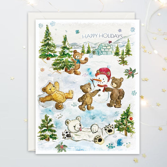 Christmas card with teddy bears building a snowman, making snow angels, and frolicking in the snow with the text "Happy Holidays"