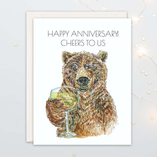 Card with a bear holding a glass of wine and 'Happy Anniversary Cheers to Us' text on a white background.
