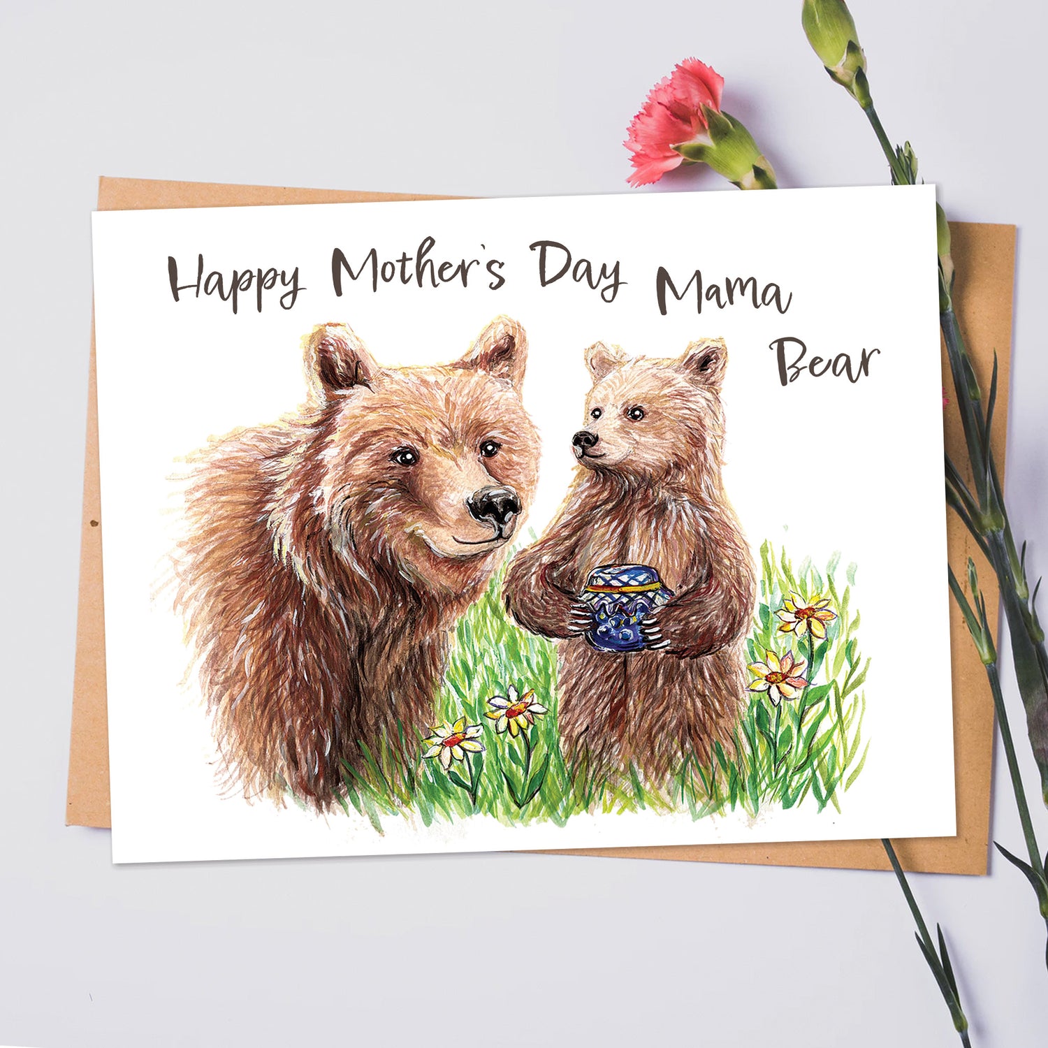 a hand drawn greeting card for mother's day. the text reads "Happy mother's day". the image is three little brown bear cubs, and a mama bear, crossing the road with trees in the background. the art is sepia toned, drawn by pyrography.