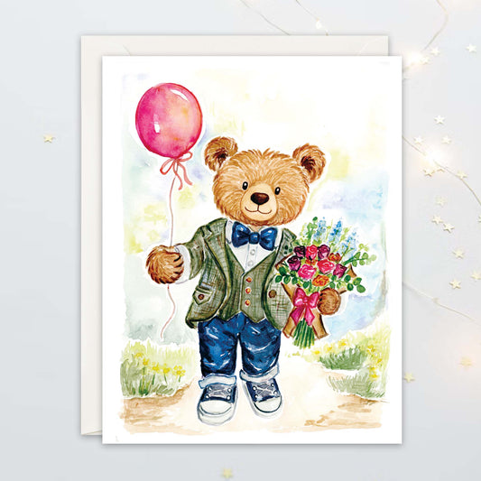 A2 size greeting card illustration of a teddy bear in a suit holding a red balloon and flowers on a white background.
