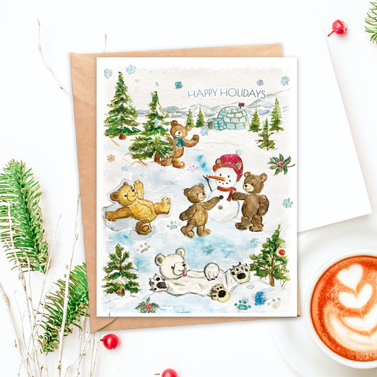 Illustration of bears making snowmen, snow angels, and waving. Igloos and snowy mountains in the distance. Card reads Happy Holidays
